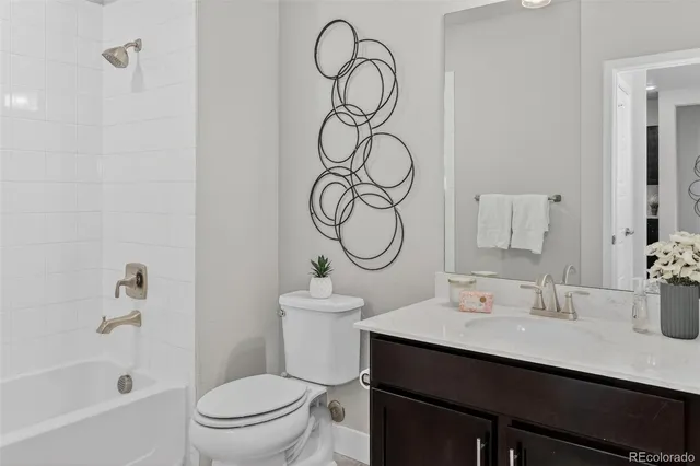 a bathroom with a sink vanity mirror and toilet