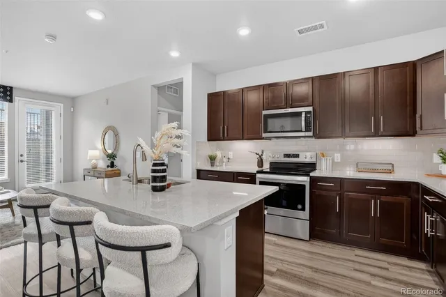 a kitchen with sink a stove and cabinets
