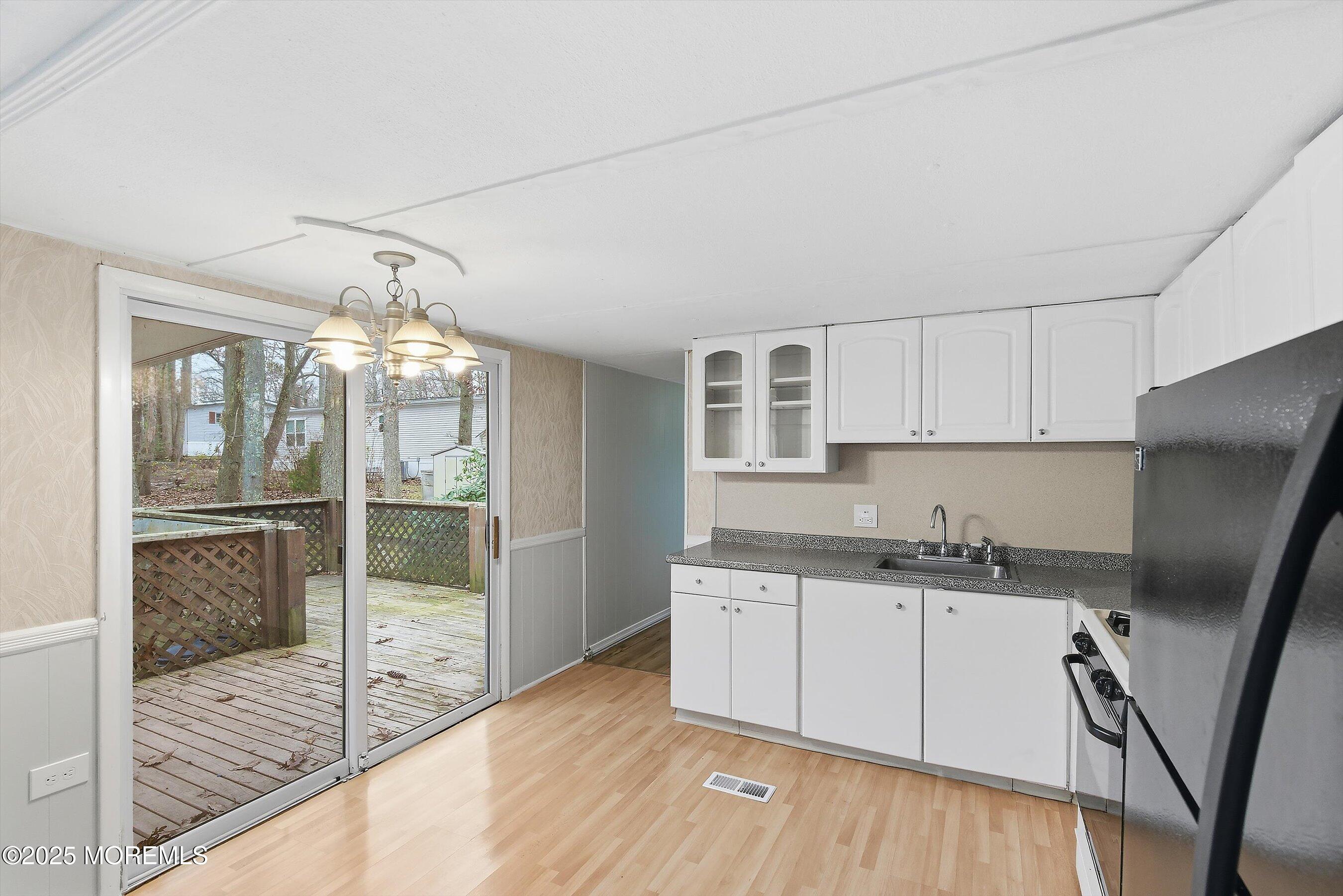 1 Loblolly Lane Jackson, NJ 08527 - Photo 4 of 19 a kitchen with granite countertop a sink window and cabinets
