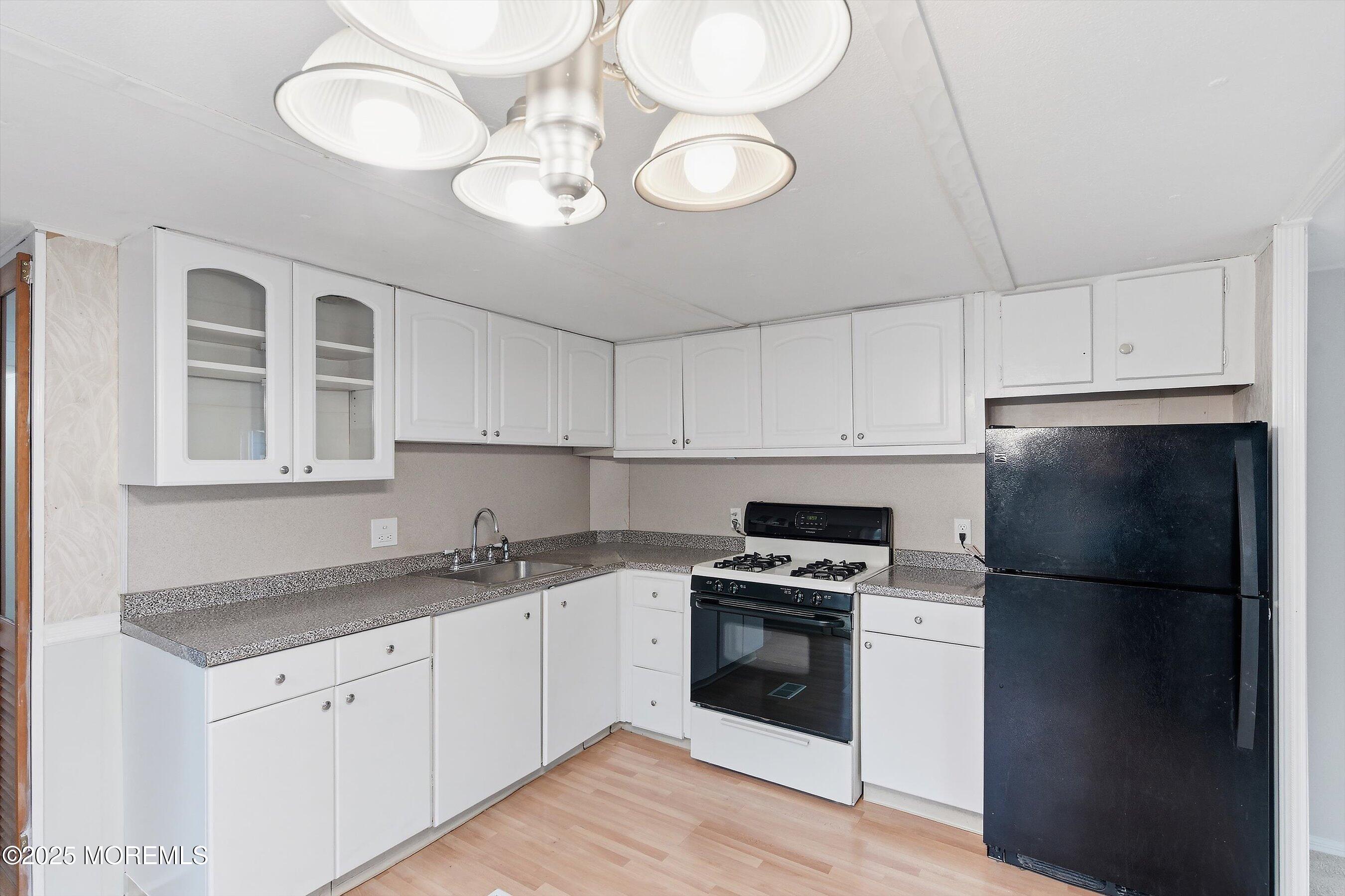 1 Loblolly Lane Jackson, NJ 08527 - Photo 5 of 19 a kitchen with cabinets stainless steel appliances and wooden floor