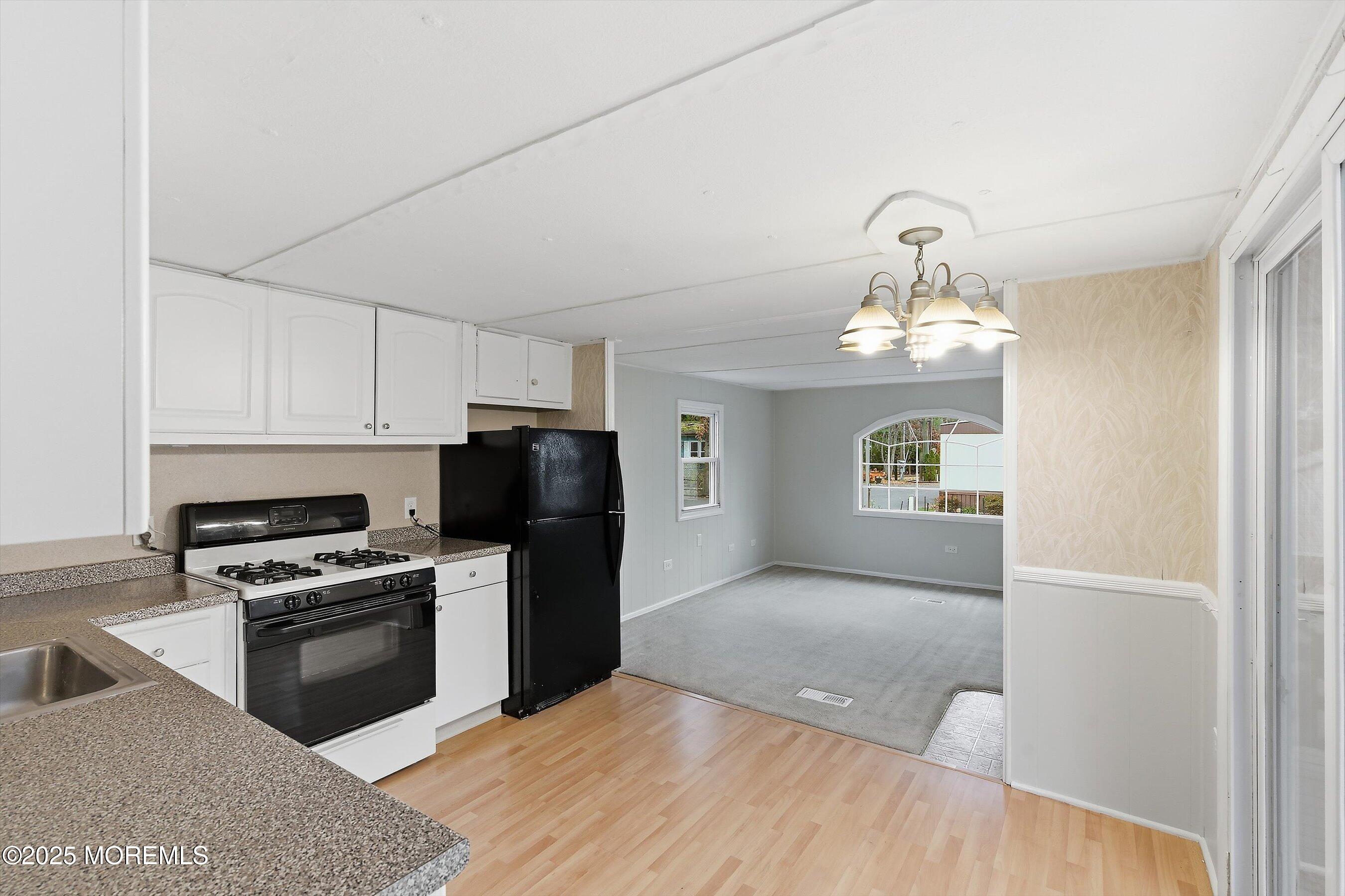 1 Loblolly Lane Jackson, NJ 08527 - Photo 6 of 19 a kitchen with granite countertop a refrigerator and a stove top oven