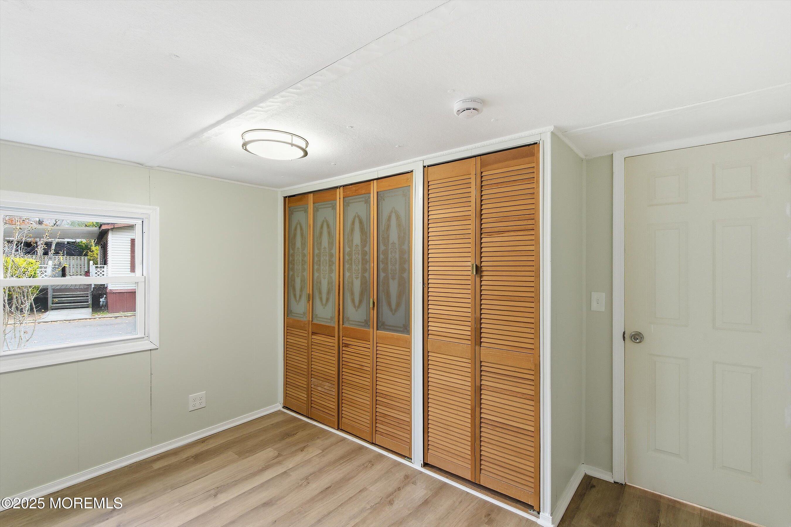 1 Loblolly Lane Jackson, NJ 08527 - Photo 8 of 19 a view of an empty room with wooden floor and a window