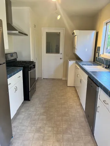 a kitchen with a sink stove and cabinets