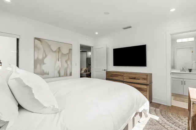 a bedroom with a bed and a flat screen tv