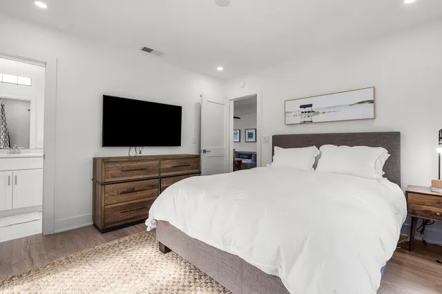 a bedroom with a bed and a flat screen tv