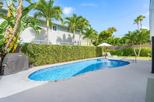 a view of a swimming pool with a yard