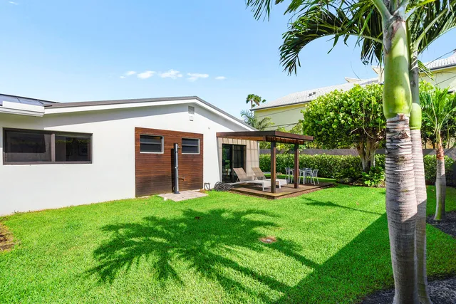 a view of a house with backyard sitting area and garden