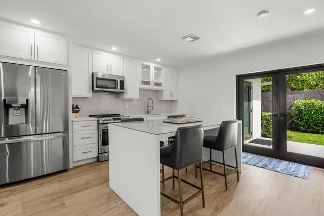 a kitchen with white cabinets and stainless steel appliances