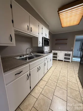 a kitchen with stainless steel appliances granite countertop a sink and a stove