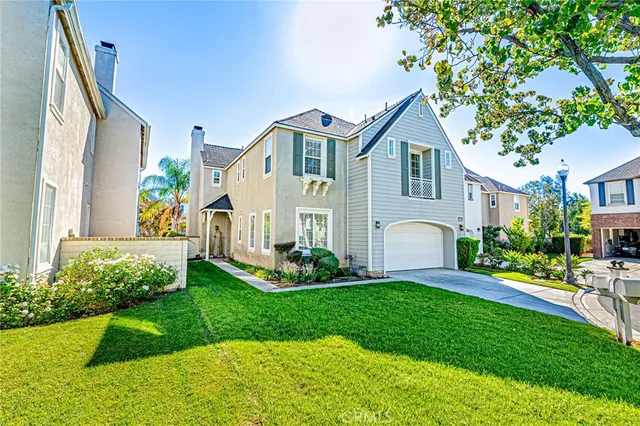 a front view of a house with a garden and plants