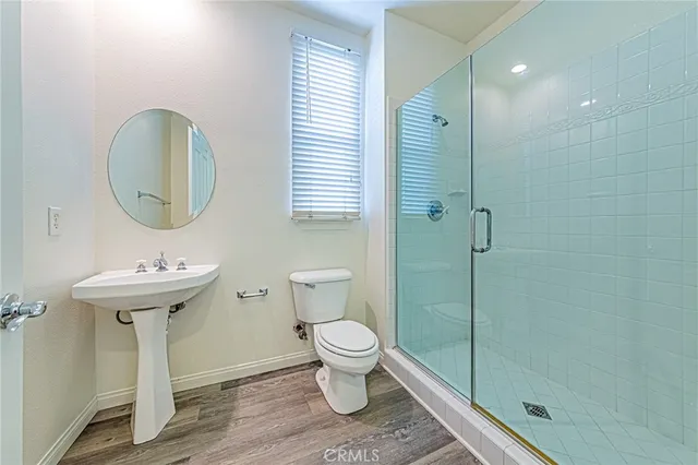 a view of a hallway with wooden floor and a fireplace
