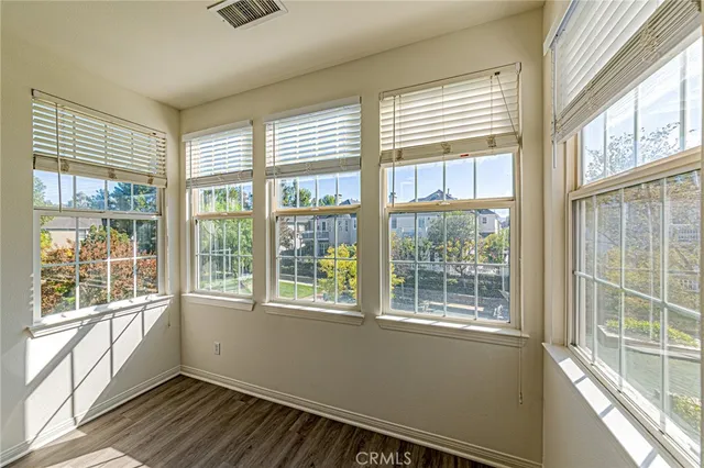 a view of a room with wooden floor and white walls