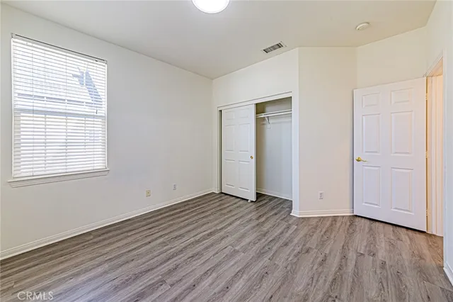 a view of a hallway with wooden floor and entryway