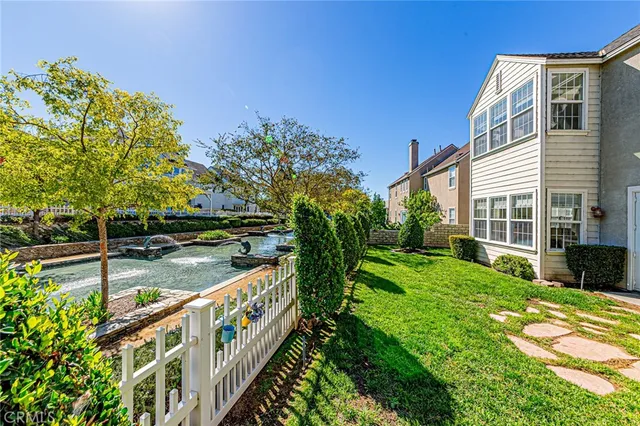 a aerial view of a house with a yard and potted plants