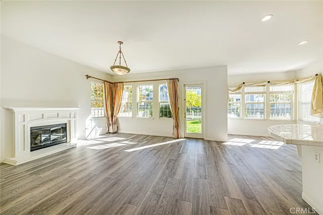a view of a kitchen with wooden floor and a sink