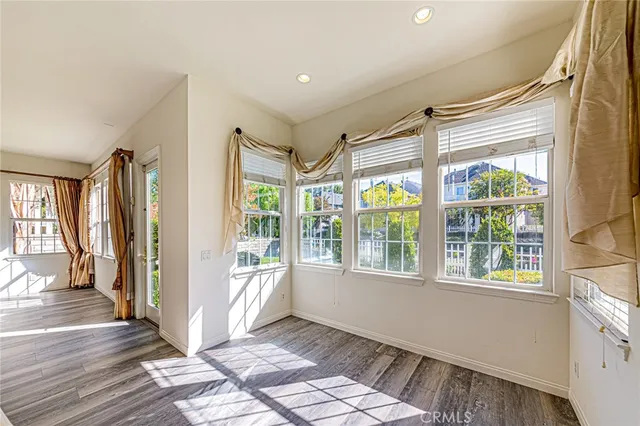 a view of kitchen with sink wooden floor and window
