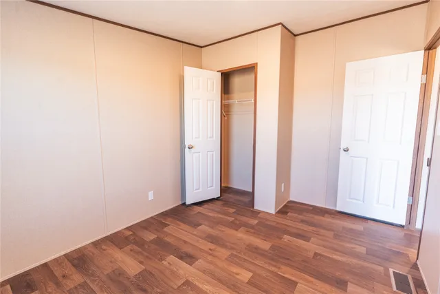 a view of a room with wooden floor