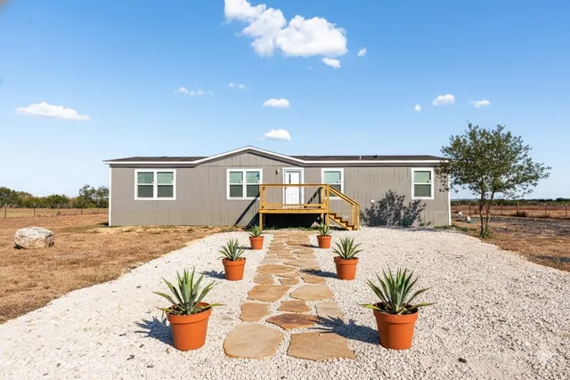 a front view of house with yard and seating space