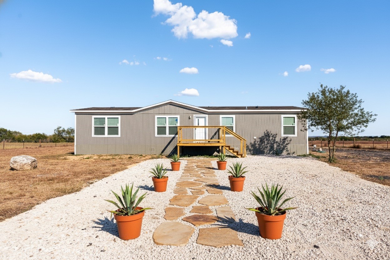 6945 Seawillow Road Lockhart, TX 78644 - Photo 2 of 22 a front view of house with yard and seating space