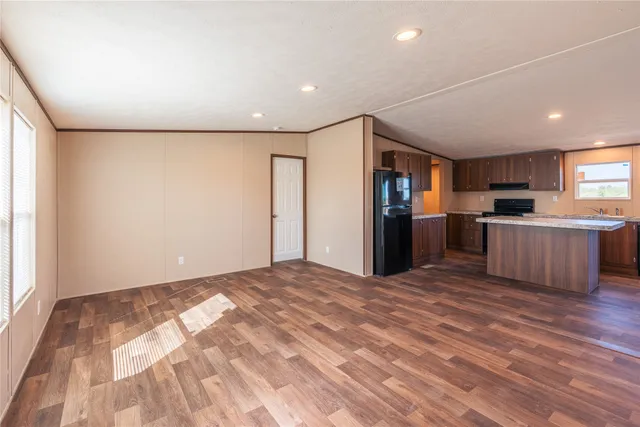 a view of a kitchen with a sink and a refrigerator