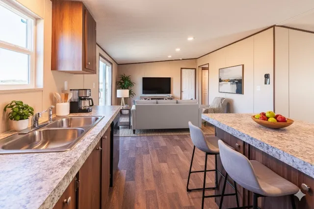 a kitchen with granite countertop a sink and a stove