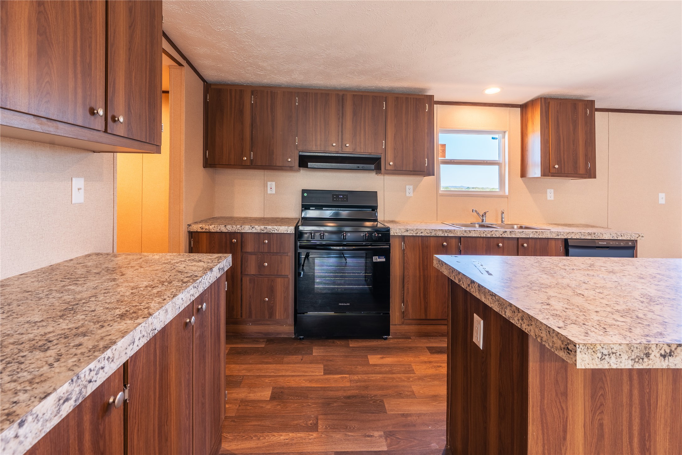 6945 Seawillow Road Lockhart, TX 78644 - Photo 7 of 22 a kitchen with a stove sink and cabinets