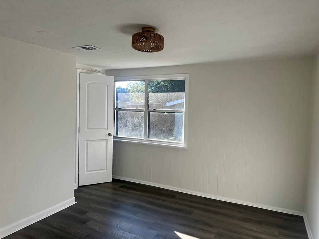 2880 Lamb Road Smiths Station, AL 36877 - Photo 12 of 17 an empty room with wooden floor and windows
