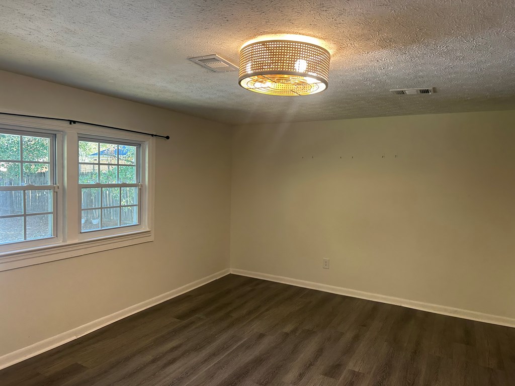 2880 Lamb Road Smiths Station, AL 36877 - Photo 13 of 17 an empty room with wooden floor and windows