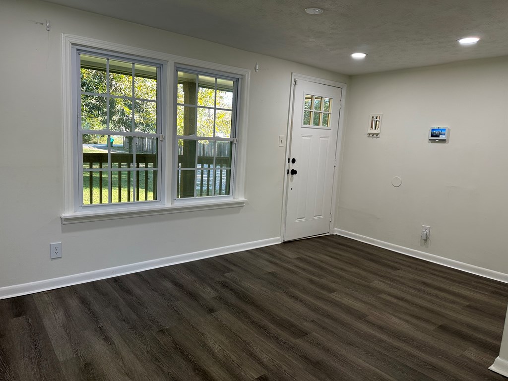 2880 Lamb Road Smiths Station, AL 36877 - Photo 16 of 17 a view of an empty room with wooden floor and a window