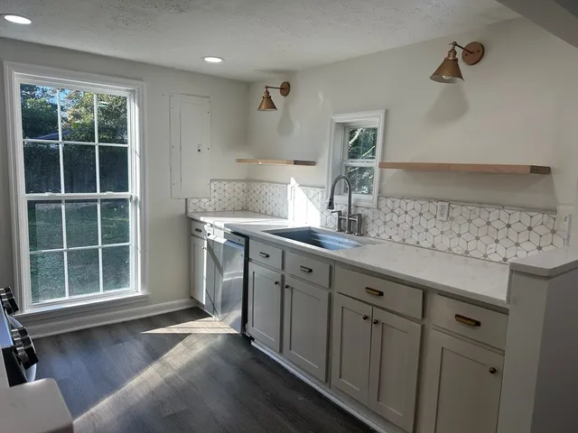a kitchen with a sink cabinets and window