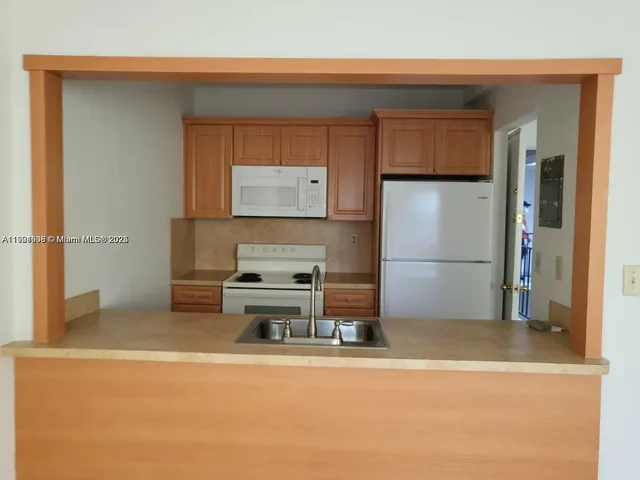 a room with a refrigerator and a stove