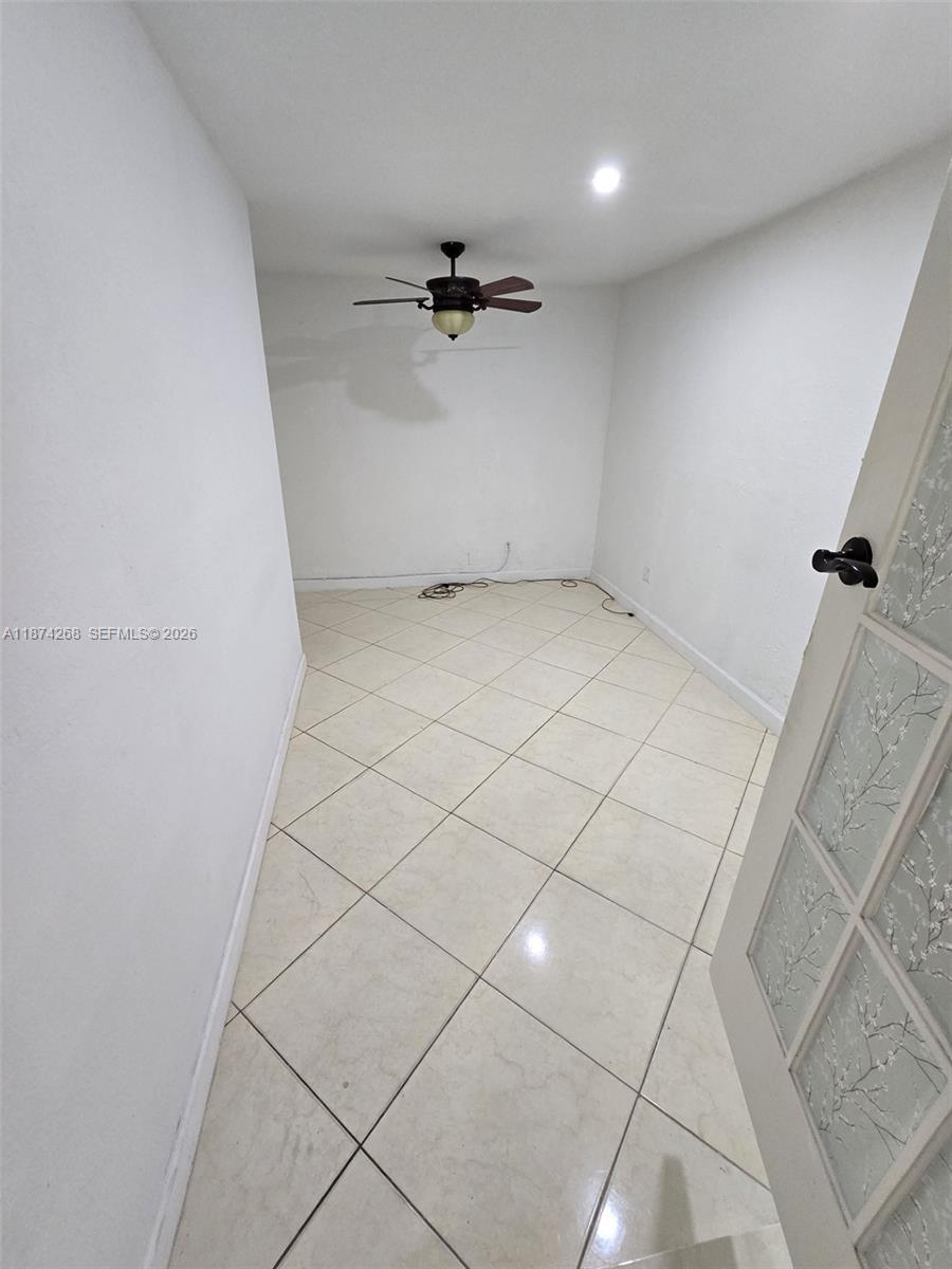 110 West 53rd Street Hialeah, FL 33012 - Photo 11 of 19 an empty room with a ceiling fan and glass door