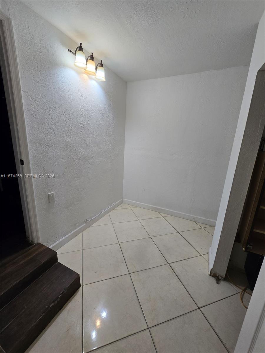 110 West 53rd Street Hialeah, FL 33012 - Photo 12 of 19 a view of an empty room and wooden floor