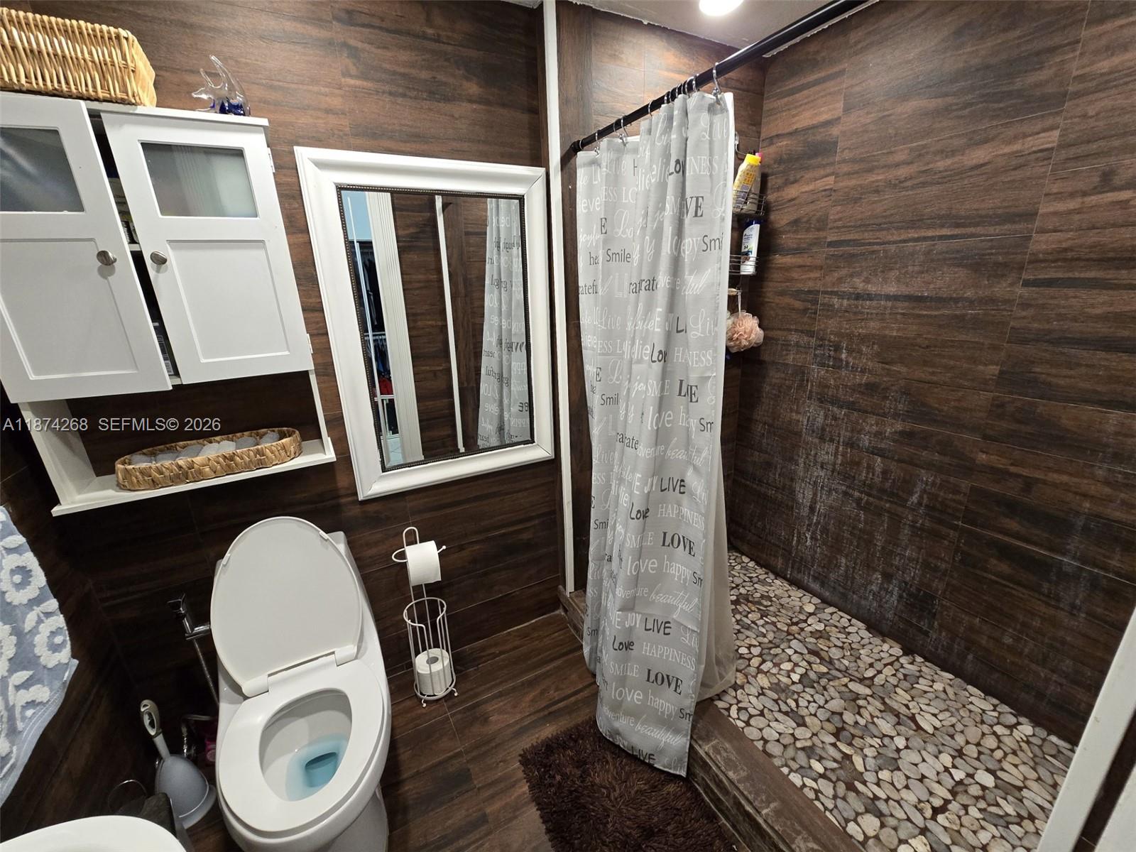 110 West 53rd Street Hialeah, FL 33012 - Photo 14 of 19 a bathroom with a toilet and a shower