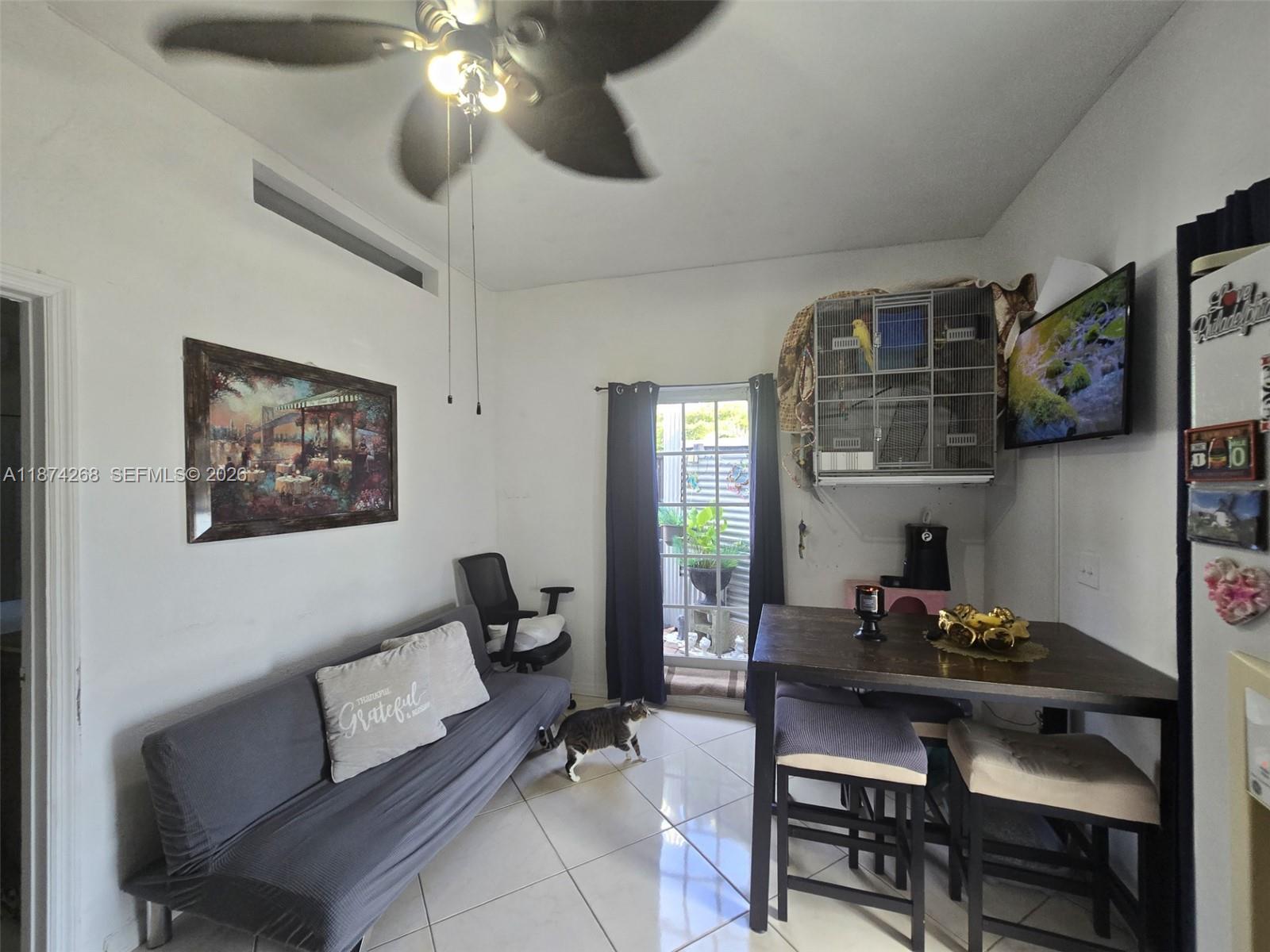 110 West 53rd Street Hialeah, FL 33012 - Photo 15 of 19 a living room with furniture a rug and a chandelier