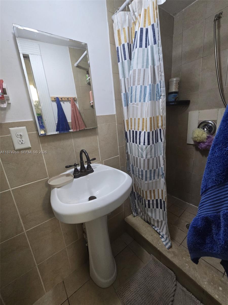 110 West 53rd Street Hialeah, FL 33012 - Photo 16 of 19 a bathroom with a sink toilet and mirror