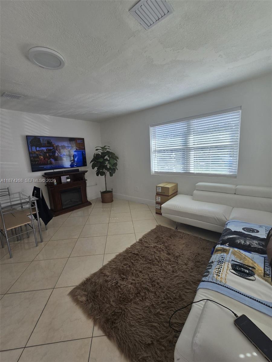 110 West 53rd Street Hialeah, FL 33012 - Photo 17 of 19 a bedroom with a bed and a stove