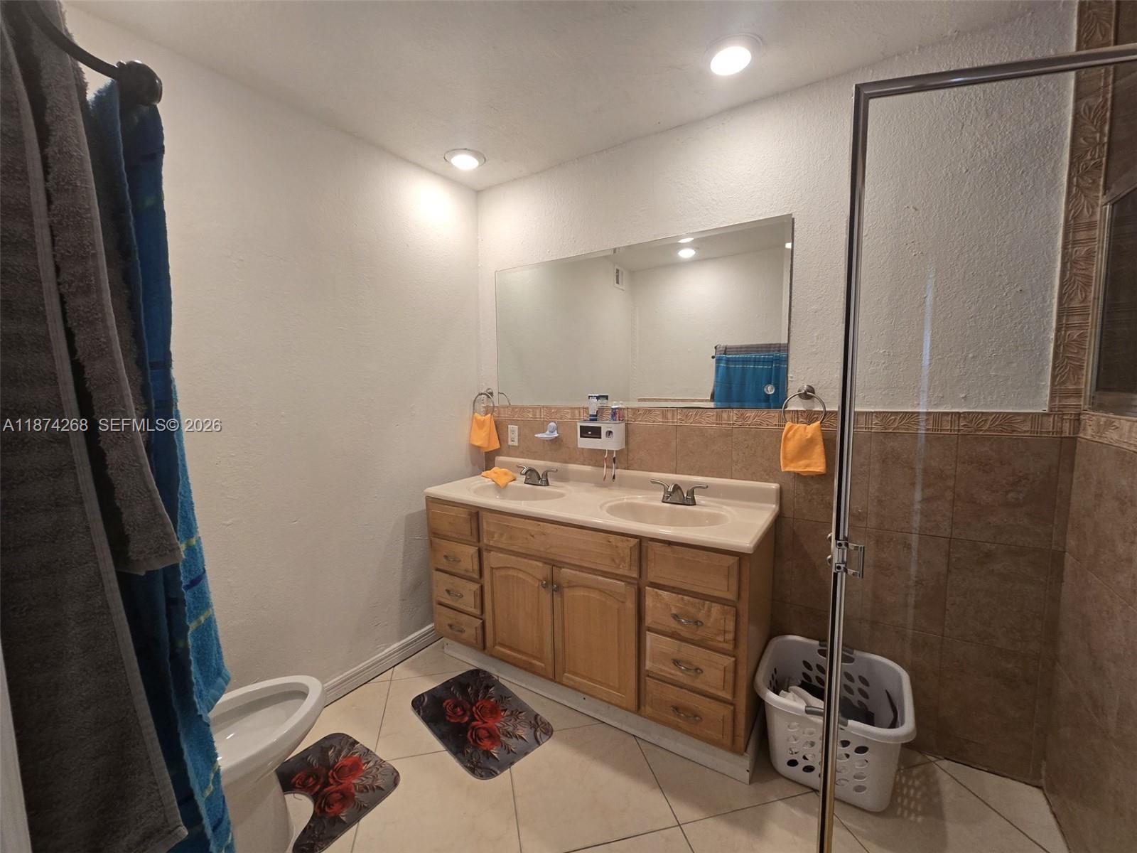 110 West 53rd Street Hialeah, FL 33012 - Photo 18 of 19 a bathroom with a sink toilet and shower