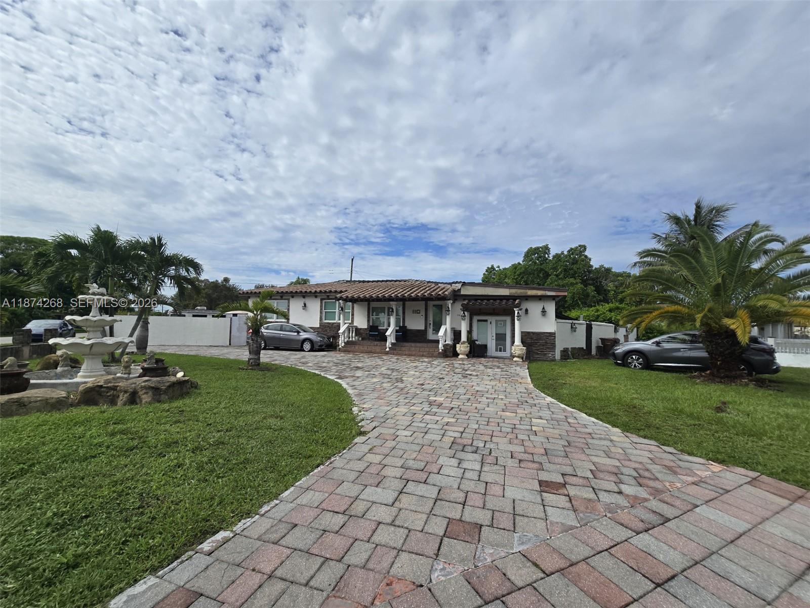 110 West 53rd Street Hialeah, FL 33012 - Photo 2 of 19 a front view of a house with garden
