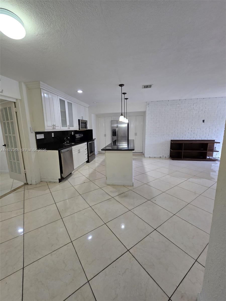110 West 53rd Street Hialeah, FL 33012 - Photo 9 of 19 a view of a kitchen with microwave and cabinets