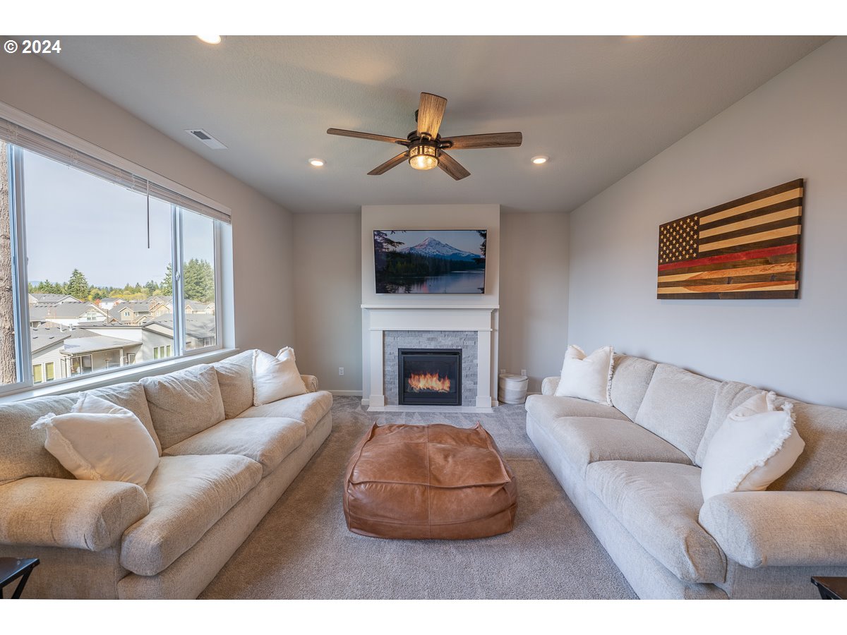 38459 Maple Street Sandy, OR 97055 - Photo 4 of 20 a living room with furniture a fireplace and a large window