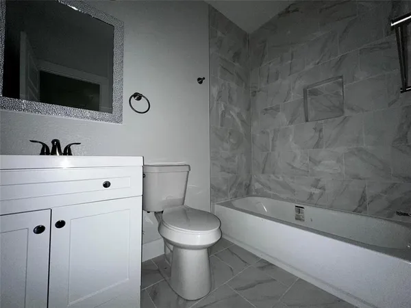 a bathroom with a sink a toilet and bathtub