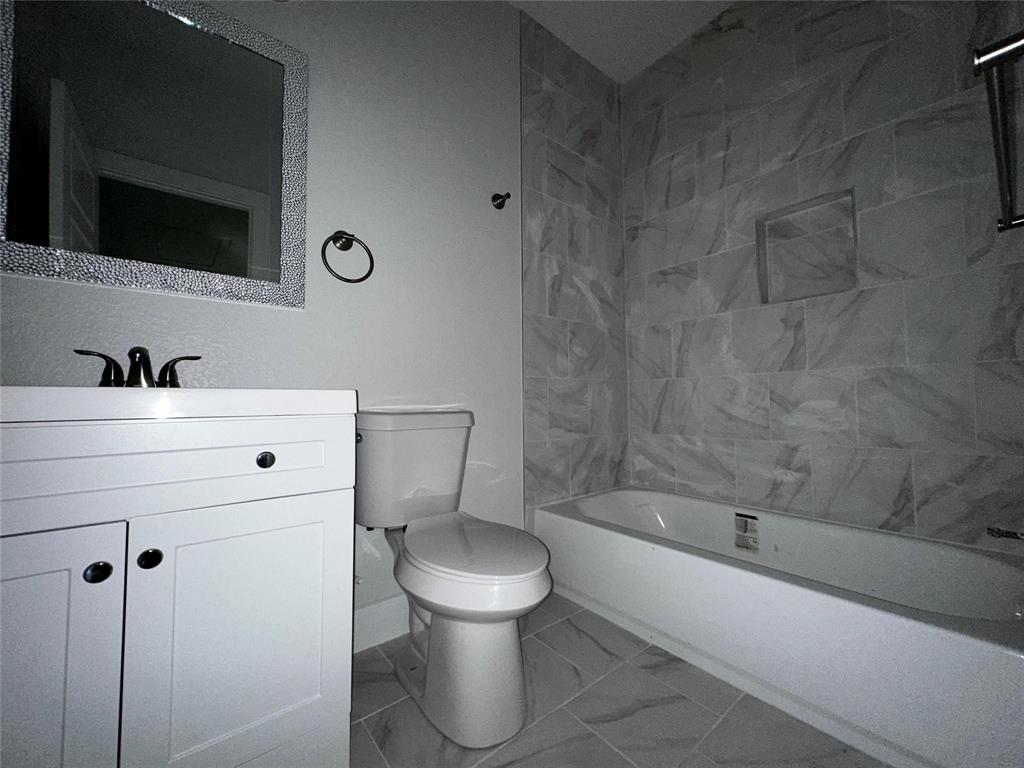 4435 Franklin Street Lancaster, TX 75134 - Photo 12 of 17 a bathroom with a sink a toilet and bathtub