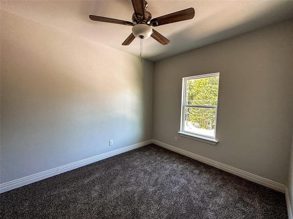 4435 Franklin Street Lancaster, TX 75134 - Photo 15 of 17 an empty room with a window and a fan