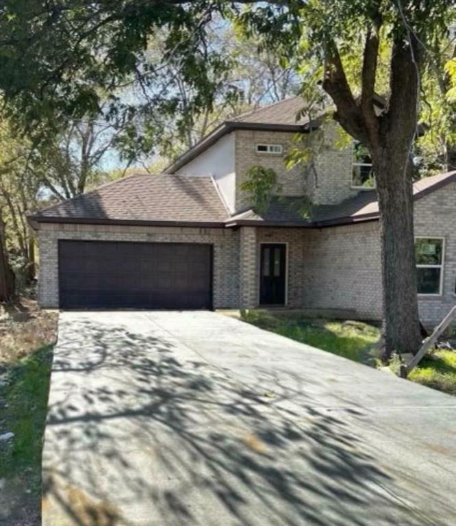 4435 Franklin Street Lancaster, TX 75134 - Photo 2 of 17 a front view of a house with a yard and garage