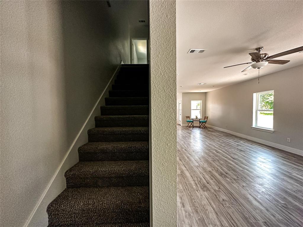 4435 Franklin Street Lancaster, TX 75134 - Photo 6 of 17 a view of an entryway with wooden floor and a rug
