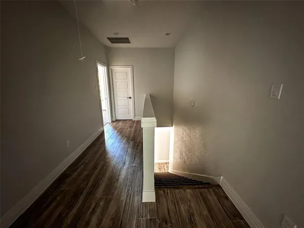 a view of gallery with wooden floor