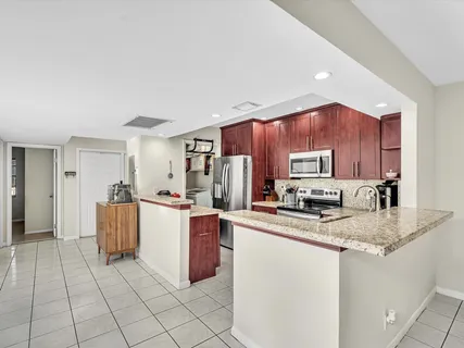 a kitchen with stainless steel appliances a refrigerator sink stove microwave and cabinets