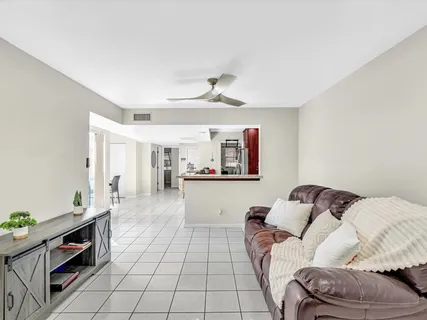 a living room with furniture and a potted plant