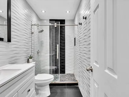 a bathroom with a toilet a sink and shower